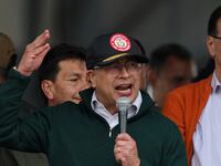 Colombia's president wearing a cap, holding a microphone, gesticulating