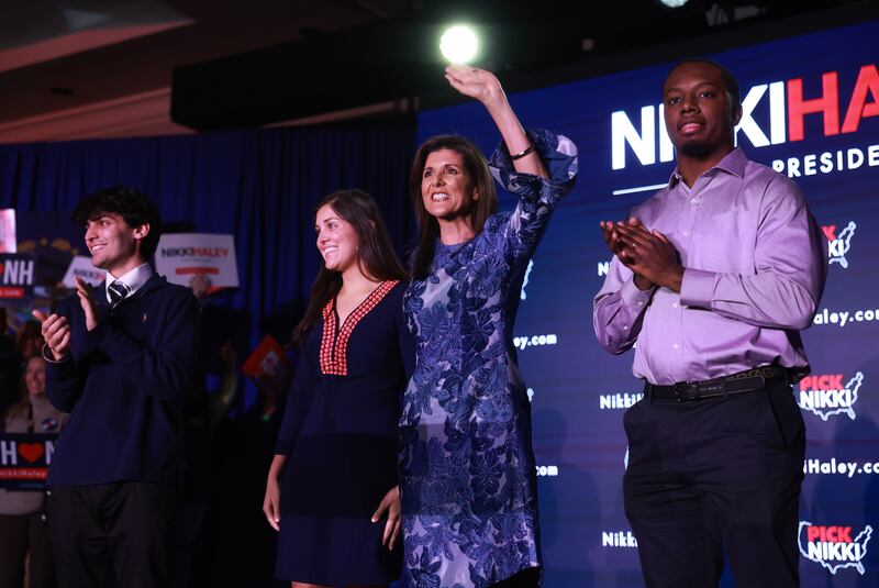 A photograph of presidential candidate Nikki Haley waving and delivering remarks at her primary night rally at the Grappone Conference Center on January 23, 2024 in Concord, New Hampshire.