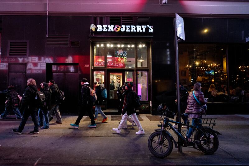 NEW YORK, NEW YORK - MARCH 04: People walk in front of a Ben & Jerry's ice cream store in Times Square on March 04, 2025 in New York City.