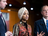 Rep.-elect Ilhan Omar speaks to the press with Rep. -elect Adam Schiff at her right and Rep. -elect Eric Swalwell at her left while they conduct a news conference.