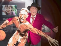 Anatomist Gunther von Hagens stands behind a full-body plastination at a permanent exhibition at the Altes Hallenbad in Heidelberg, Germany, 27 September 2017.