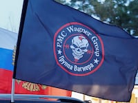 A flag with the logo of Wagner private mercenary group is attached to a car during an automobile rally at a patriotic festival marking Russia's National Flag Day in the Moscow region, Russia, August 23, 2023