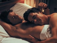 Jonathan Bailey and Matt Bomer in bed together in a still from ‘Fellow Travelers’