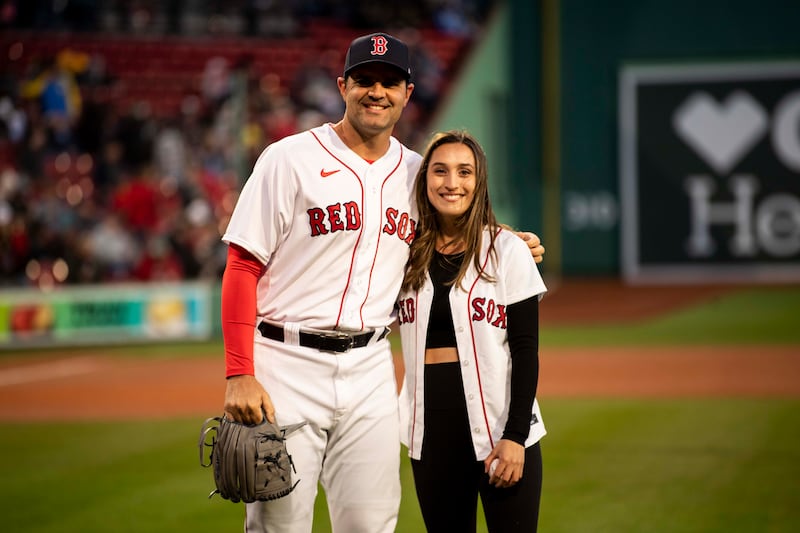Karenna Groff poses for a photograph with Richard Bleier after throwing out a ceremonial first pitch during a pre-game ceremony in recognition of Women's Appreciation Night before a game between the Boston Red Sox and the Pittsburgh Pirates on April 3, 2023 at Fenway Park in Boston, Massachusetts.