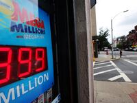 A Mega Millions sign is illuminated inside a store.