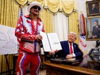 U.S. President Donald Trump, accompanied by entertainer Kid Rock, signs an executive order in the Oval Office of the White House on March 31, 2025 in Washington, DC.