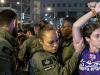 A demonstrator is detained by a member of security forces during a protest against Israeli Prime Minister Benjamin Netanyahu's government and to call for the release of hostages kidnapped in the deadly October 7 attack in Tel Aviv, Israel, June 1, 2024.