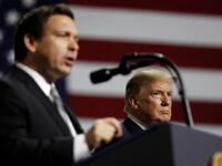 U.S. President Donald Trump listens as Republican Florida governor candidate Ron DeSantis speaks during a Make America Great Again Rally.