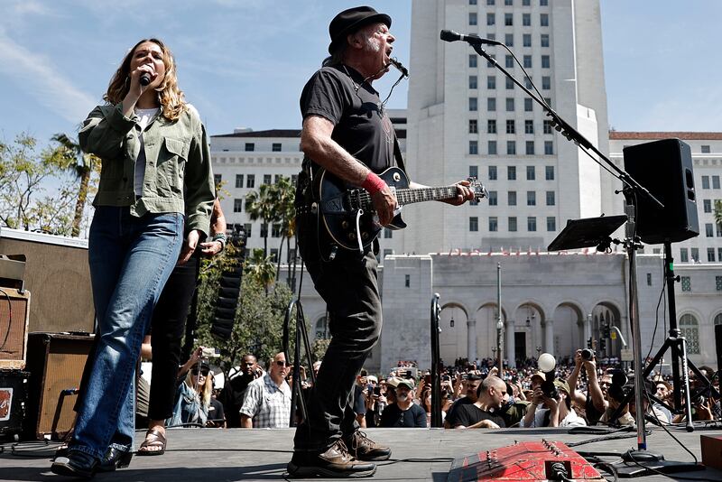LOS ANGELES, CALIFORNIA - APRIL 12: Neil Young (C) and Maggie Rogers perform during the ‘Fighting Oligarchy’ tour at Grand Park on April 12, 2025 in Los Angeles, California. An estimated 36,000 people attended the rally where
U.S. Sen. Bernie Sanders (I-VT) and Rep. Alexandria Ocasio-Cortez (D-NY) spoke. (Photo by Mario Tama/Getty Images)