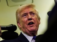 President Donald Trump gaggles with reporters while aboard Air Force One on February 6, 2026 en route to Palm Beach, Florida.