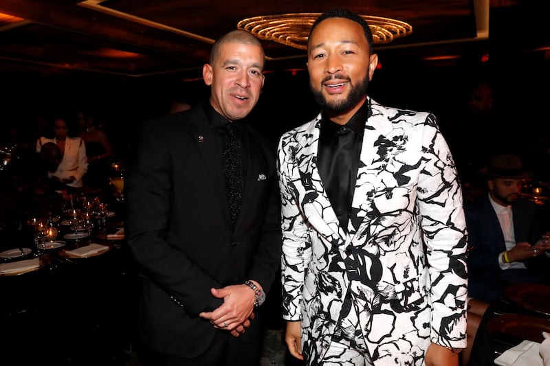 A photo of Rigo Morales and John Legend at the 64th Annual Grammy Awards in April 2022.