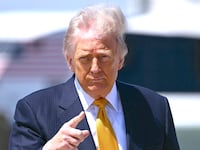 US President Donald Trump gestures prior boarding Air Force One at Joint Base Andrews, Maryland, on May 12, 2026.