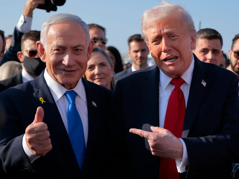 President Donald Trump speaks to Israeli Prime Minister Benjamin Netanyahu at Ben Gurion International Airport before boarding his plane to Sharm El-Sheikh, on October 13, 2025 in Tel Aviv, Israel.