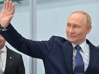 Russia's President Vladimir Putin waves as he visits a plant of Omega-Sea entreprise in the far eastern port city of Magadan on the Sea of Okhotsk on August 15, 2025, on his way to Alaska to meet with US' President.