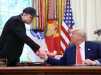 Elon Musk (left) shakes hands with President Donald Trump as they speak to reporters in the Oval Office of the White House on May 30, 2025 in Washington, DC.