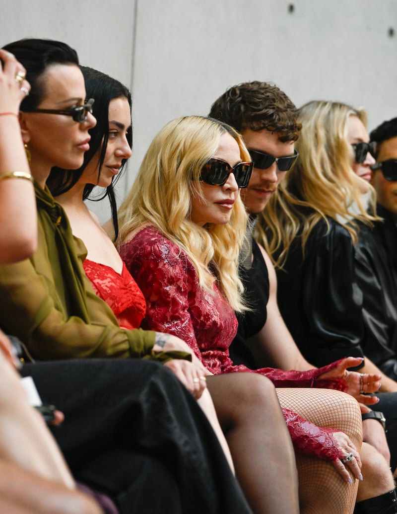 Actress Debi Mazar, Charli XCX, Madonna, actor Connor Storrie, and supermodel Kate Moss sit front row at the Saint Laurent fashion show during Paris Men's Spring-Summer 2027 Fashion Week on June 23, 2026, in Paris, France.
