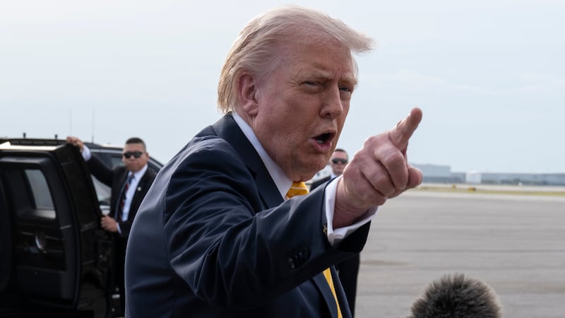 President Donald Trump speaks to journalists before boarding Air Force One at Palm Beach International Airport on May 2, 2026 in Palm Beach, Florida.