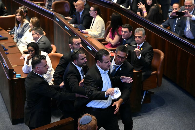 Israeli Knesset member Ayman Odeh being escorted out after interrupting Donald Trump's speech.