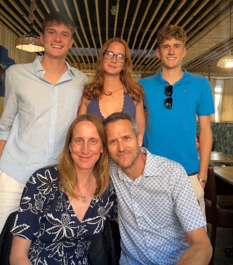 Kim Oakhill poses in a family photo with her three children and husband on the Crowdfunding website.