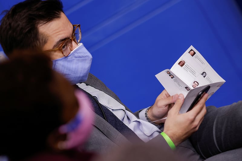 White House Deputy Press Secretary TJ Ducklo holds a paper sheet with names and headshots of reporters during a press briefing at the White House.