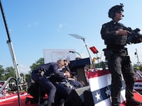 Secret service agents cover former president Donald Trump
