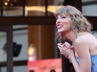 Taylor Swift smiles at the premiere of her concert film in October 2023.