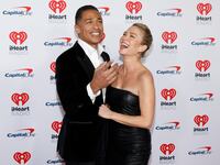 T.J. Holmes and Amy Robach pose for a photo together.