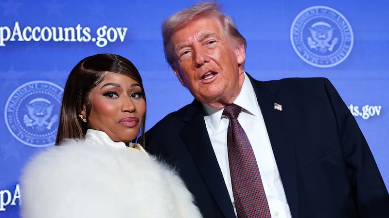 WASHINGTON, DC - JANUARY 28: Musician Nicki Minaj (L) joins U.S. President Donald Trump on stage as he delivers remarks during the Treasury Department's Trump Accounts Summit at Andrew W. Mellon Auditorium on January 28, 2026 in Washington, DC. "Trump Accounts" are a portion of recently passed tax and spending legislation where the federal government will deposit $1,000 into investment accounts for every child born between 2025 and 2028 once parents sign their children up while filing their income taxes. (Photo by Win McNamee/Getty Images)