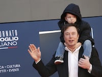 Elon Musk holds his son X on his shoulders