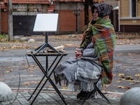 "A volunteer seats near a Starlink terminal constructed for local residents at a street, as Russia's attack on Ukraine continues, in Kherson, Ukraine.