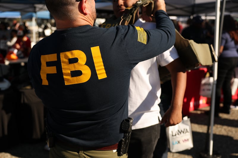 A student tries on a Federal Bureau of Investigation (FBI) vest while learning about jobs with the agency during the 10th annual Aviation Career Day at Los Angeles International Airport (LAX) in Los Angeles, California on October 30, 2025.