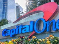 The sun flares over the top of the Capital One logo outside of their corporate headquarters complex on February 8, 2024, in McLean, Va.