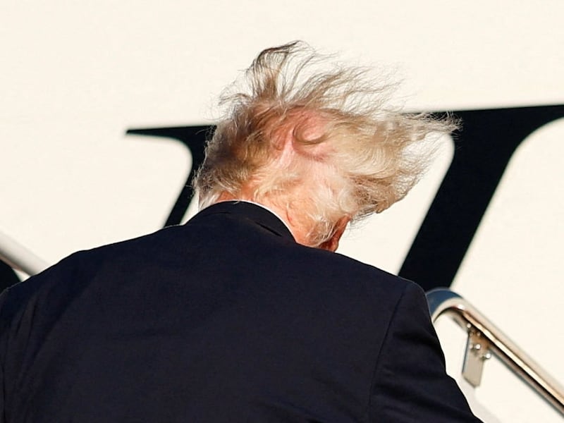 The hair of US President Donald Trump is swept by the wind as he boards Air Force One for a trip to Daytona Beach, Florida, at Joint Base Andrews, Maryland, US, October 30, 2026.