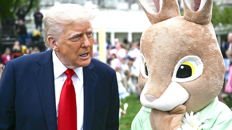 US President Donald Trump speaks as he stands next to an constumed Easter bunny