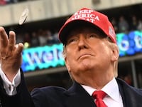 President Trump tosses a coin in a football stadium