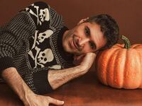 Danny Pellegrino laying with his head on a pumpking