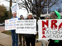 A group of people protest against individual armament outside the National Rifle Association (NRA) building in Fairfax, Virginia.