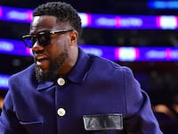 Kevin Hart walks courtside as he attends a basketball game in Los Angeles.