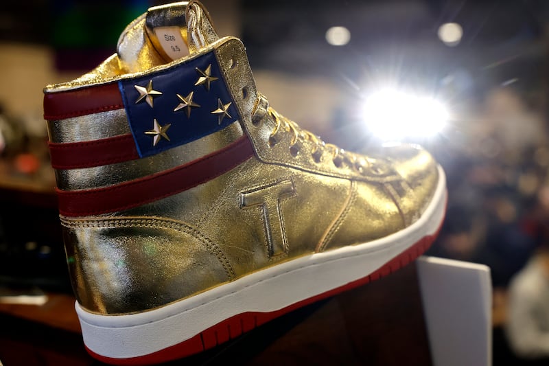 The Gold Trump shoes that are being sold at Sneaker Con