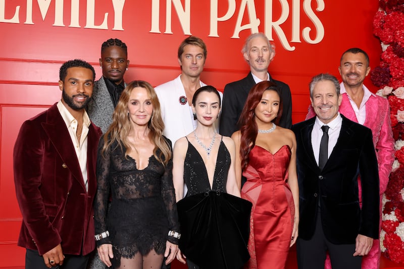 The cast of 'Emily in Paris,' including Lucien Laviscount, Samuel Arnold, Philippine Leroy-Beaulieu, Lucas Bravo, Lily Collins, Bruno Gouery, Ashley Park, Darren Star, and William Abadie, attend the Season 5 premiere at Le Grand Rex in Paris on December 15, 2025.
