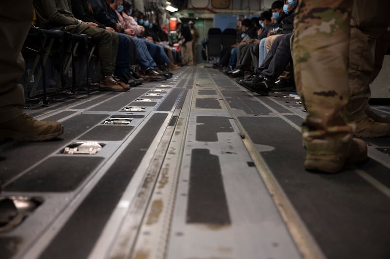 In this handout provided by the U.S. Department of Defense, immigrants await takeoff in a military plane for a removal flight at the Tucson International Airport, on January 23, 2025 in Tucson, Arizona.