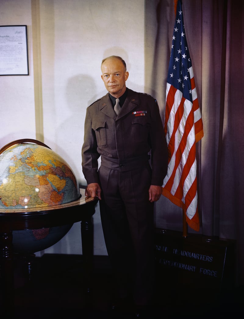 Dwight D. Eisenhower is shown in a portrait, standing near a globe and a flag.