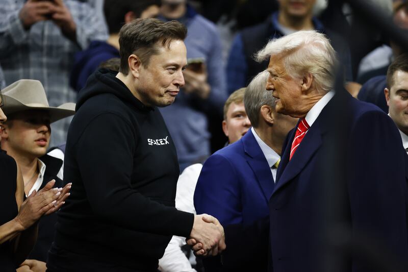 President Donald Trump greets senior advisor Elon Musk during the Division I Men's Wrestling Championship on March 22.