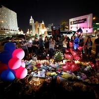 People gather at a makeshift memorial in the middle of Las Vegas Boulevard following the mass shooting in Las Vegas, Nevada, U.S., October 4, 2017.