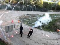 Fireworks erupt around police officers during protests in Atlanta
