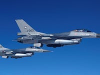 Netherlands’ Air Force F-16 fighter jets fly alongside an aircraft simulating aerial interceptions during a media day illustrating how NATO Air Policing safeguards the Allies’ airspace in the northern and northeastern region of the Alliance, July 4, 2023.