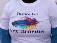 People attend a candlelight vigil for 16-year-old nonbinary student Nex Benedict.