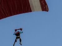 A skydiver steers their parachute.