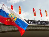Russian flag is seen next to banners saying "Victory" on Victory Day.