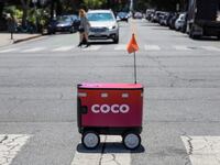 Santa Monica, CA, Wednesday, July 23, 2025 - A Coco food delivery robots crosses 11th St. as it travels along Montana Ave. from Kreation Kafe. (Robert Gauthier/Los Angeles Times via Getty Images)